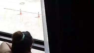 Lady fucks in front of a transparent glass in Indian porn